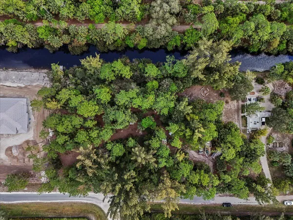 an aerial view of a house with a yard and garden