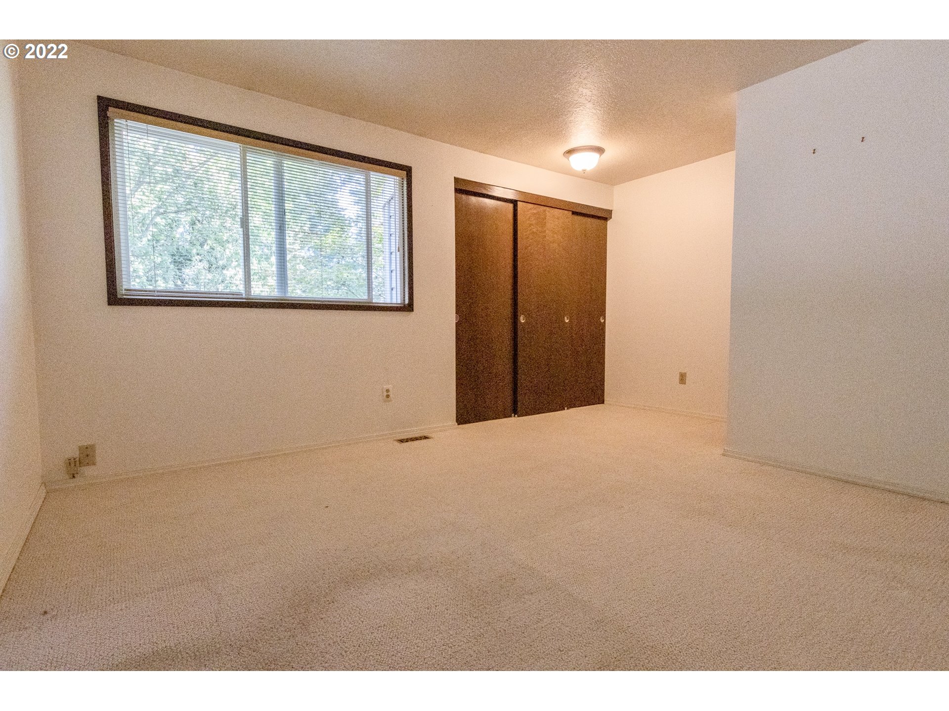 4880 Southwest Scholls Ferry Road, Unit 23 Portland, OR 97225 - Photo 12 of 17 a view of an empty room with a window