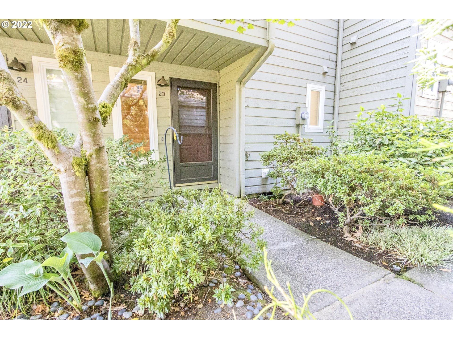 4880 Southwest Scholls Ferry Road, Unit 23 Portland, OR 97225 - Photo 2 of 17 a view of a backyard with plants