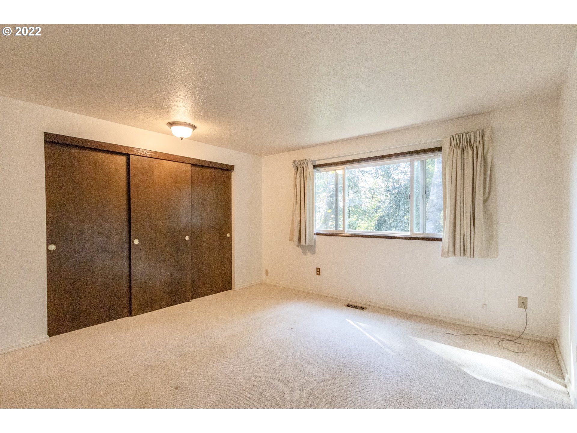 4880 Southwest Scholls Ferry Road, Unit 23 Portland, OR 97225 - Photo 10 of 17 a view of an empty room with a window