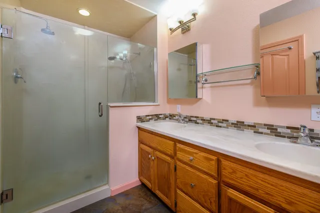 a bathroom with a granite countertop sink and a mirror