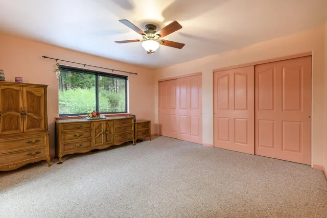 a view of an empty room with a ceiling fan