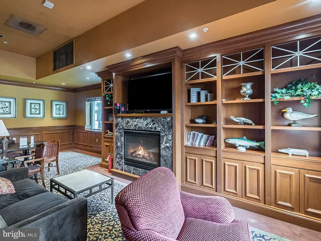 a dining room with furniture and a chandelier