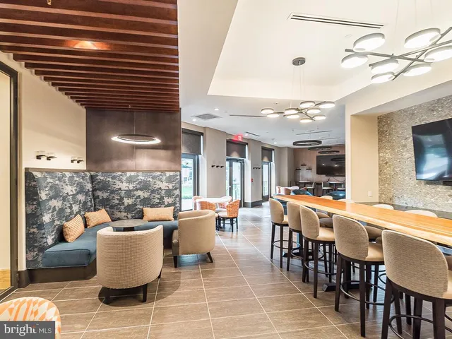 a living room with furniture a table and a large window