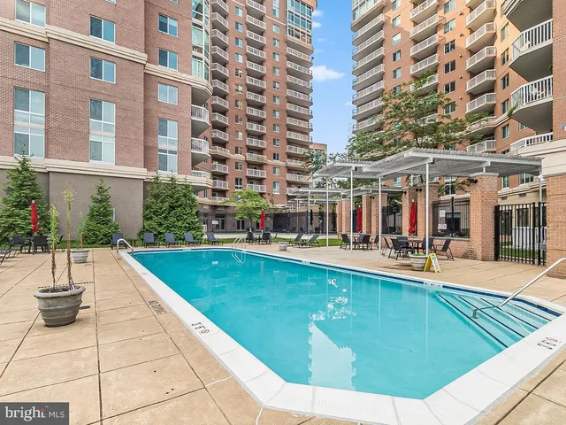 a view of a swimming pool with outdoor seating