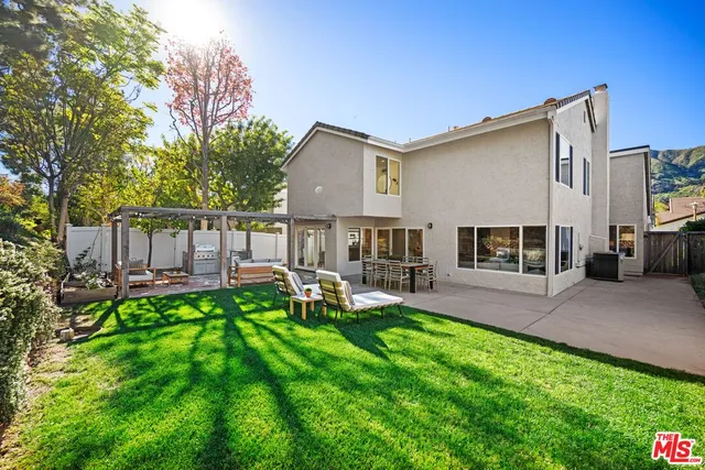a kitchen with a sink a stove cabinets and a window