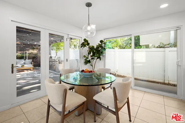 a bedroom with a bed and large window
