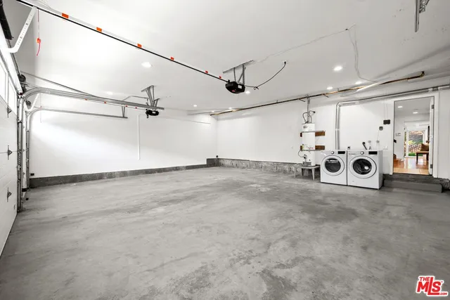 a living room with furniture a fireplace and a large window