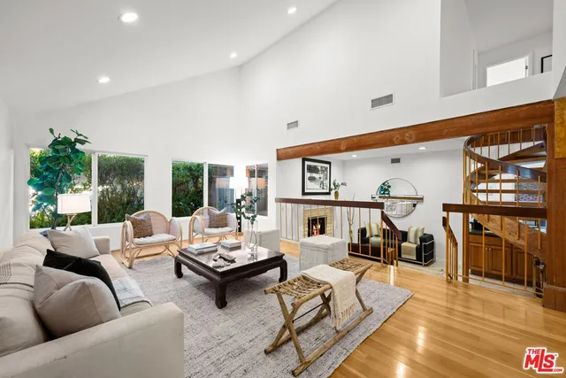 a living room with furniture a rug and a fireplace