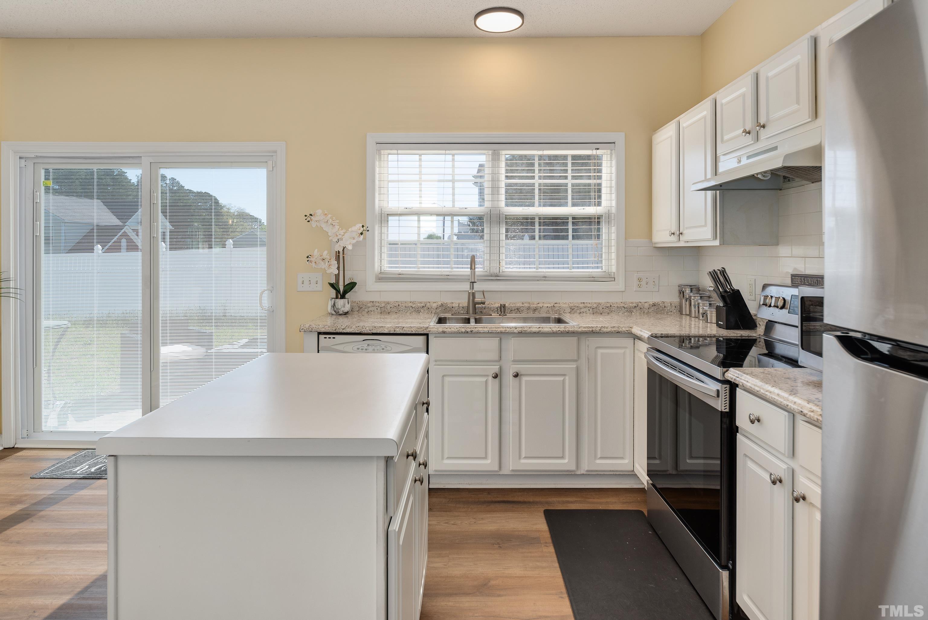2901 Ranburne Drive Raleigh, NC 27610 - Photo 16 of 29 a kitchen with stainless steel appliances granite countertop a sink stove and refrigerator