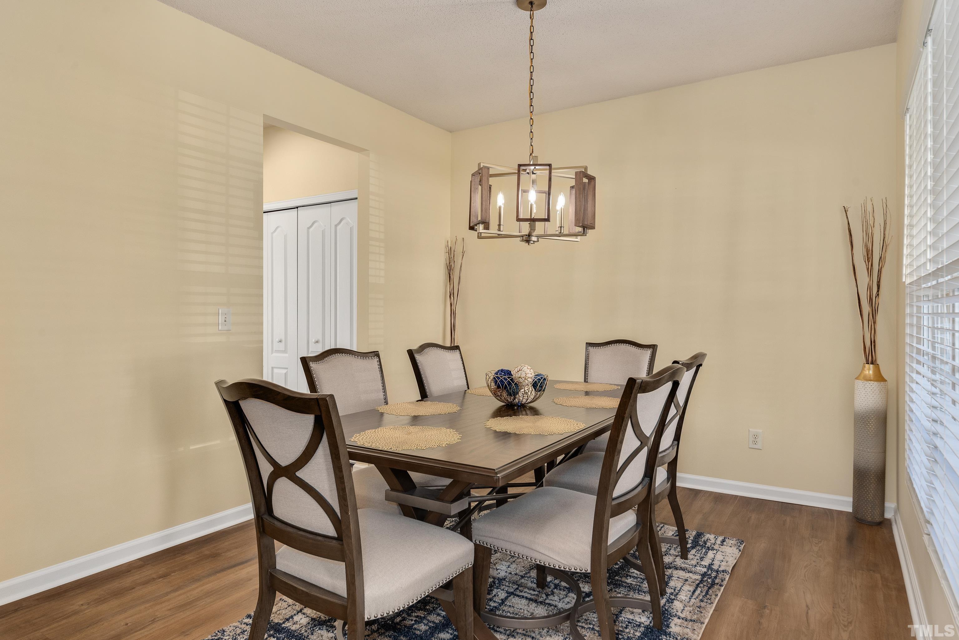 2901 Ranburne Drive Raleigh, NC 27610 - Photo 18 of 29 a view of a dining room with furniture wooden floor and chandelier