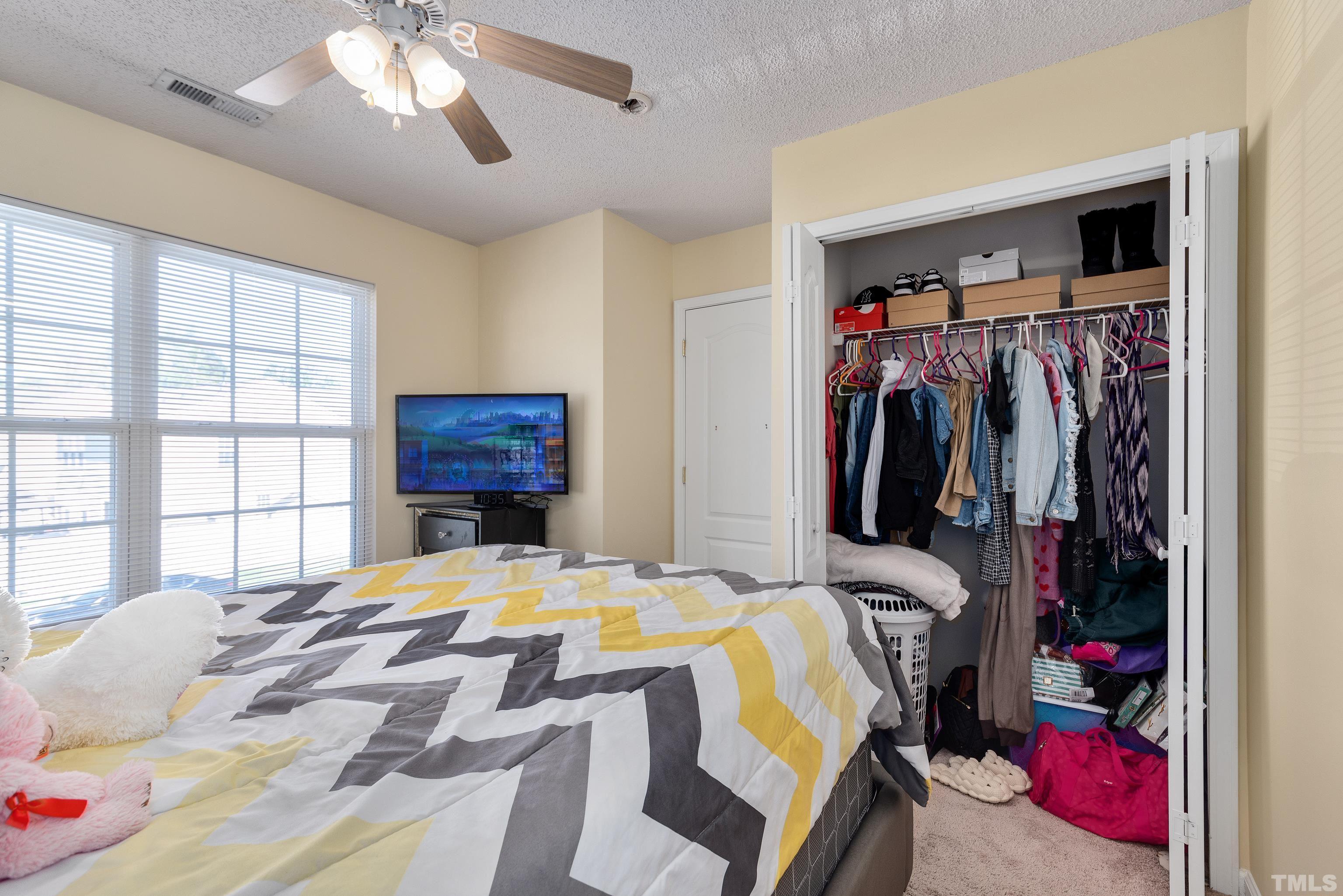 2901 Ranburne Drive Raleigh, NC 27610 - Photo 25 of 29 a bed sitting in a bedroom next to a window