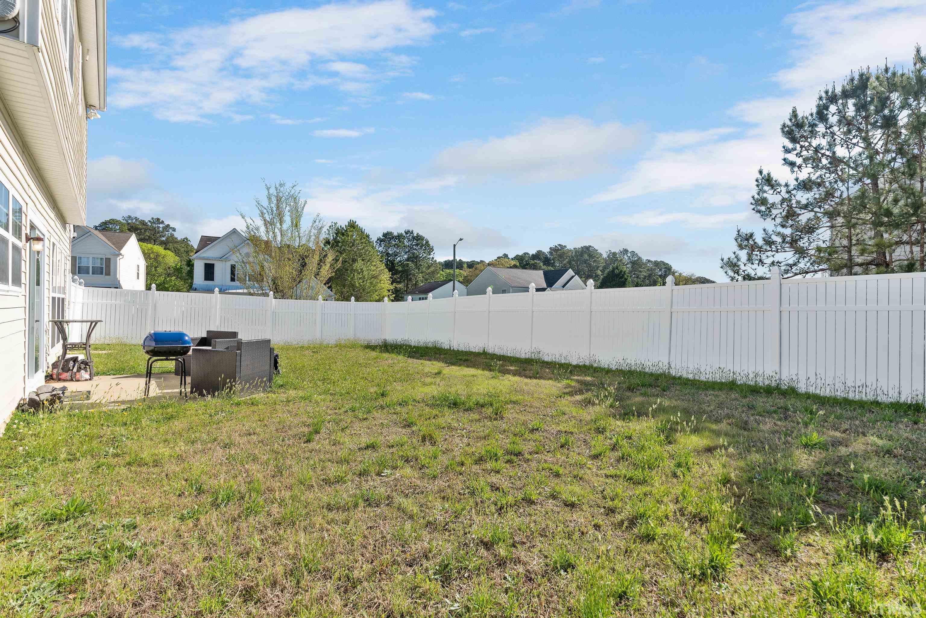 2901 Ranburne Drive Raleigh, NC 27610 - Photo 29 of 29 a backyard of a house with table and chairs