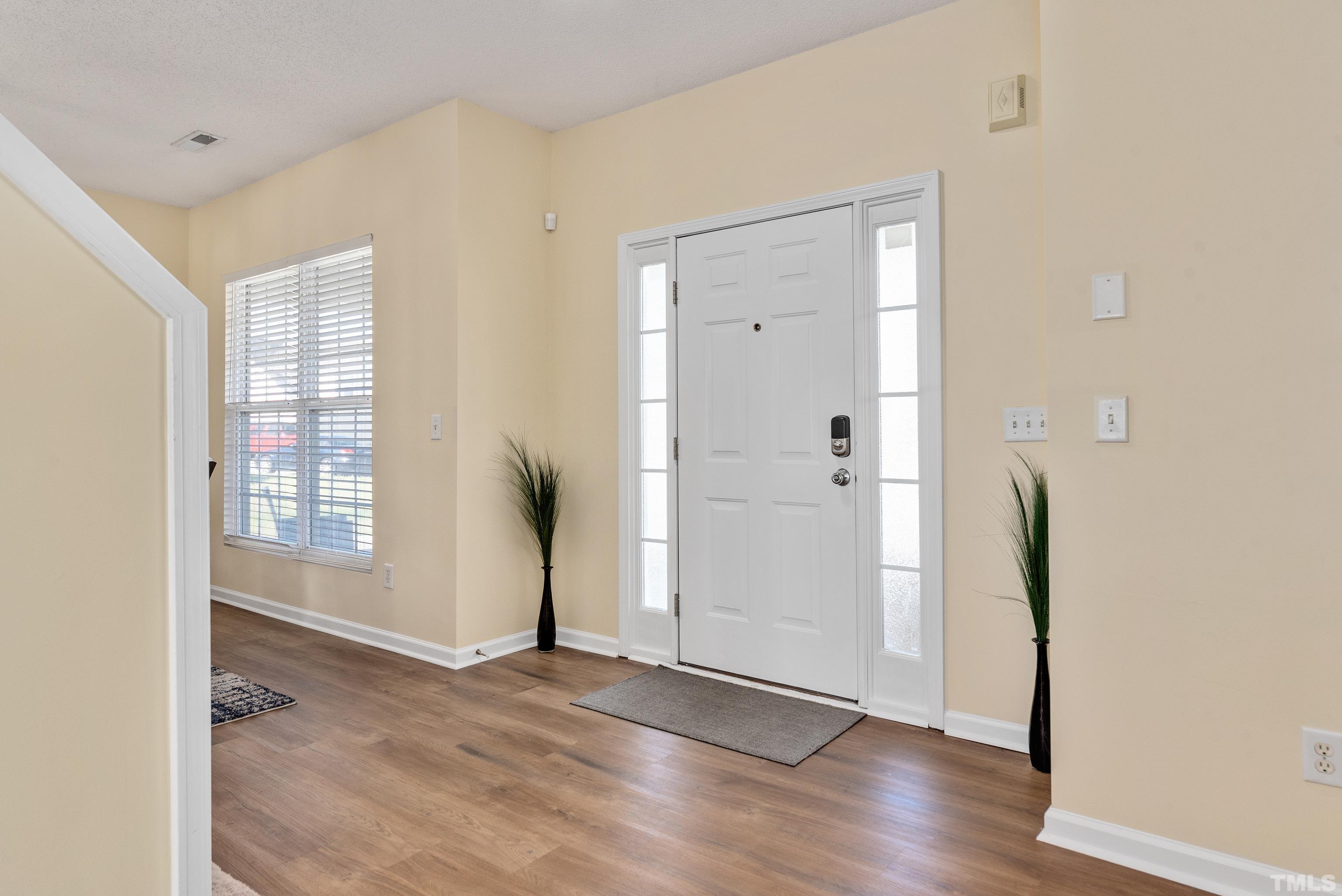 2901 Ranburne Drive Raleigh, NC 27610 - Photo 6 of 29 an empty room with wooden floor and a window