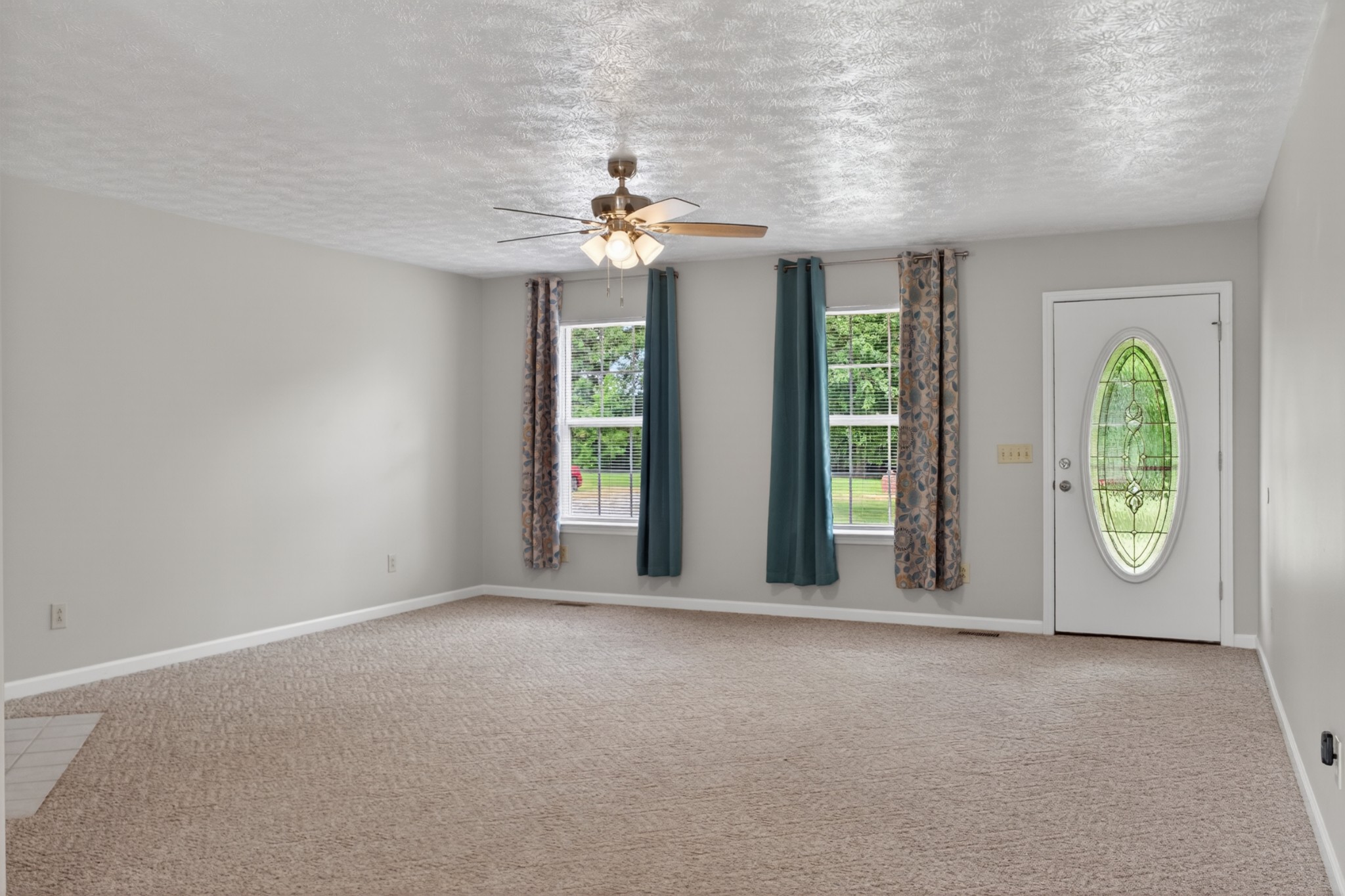 618 Lear Road Portland, TN 37148 - Photo 11 of 29 an empty room with windows and chandelier
