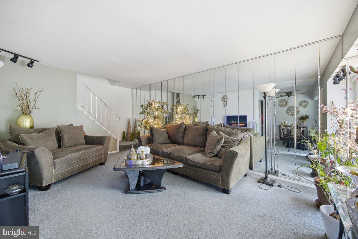 208 Timber Creek Road Lindenwold, NJ 08021 - Photo 4 of 12 a living room with furniture and a chandelier