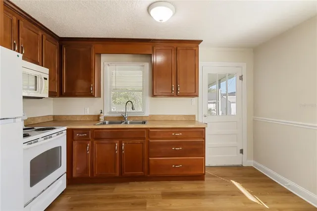 a kitchen with sink and cabinets