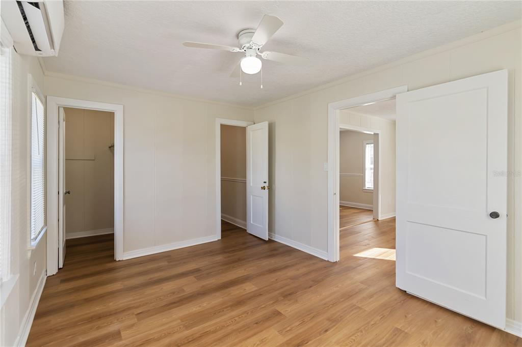 712 4th Street St. Cloud, FL 34769 - Photo 16 of 30 an empty room with wooden floor and a ceiling fan