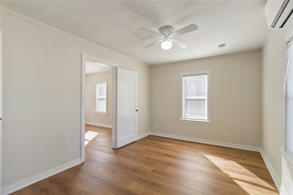 712 4th Street St. Cloud, FL 34769 - Photo 17 of 30 a view of an empty room with wooden floor and a window