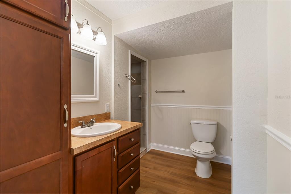 712 4th Street St. Cloud, FL 34769 - Photo 19 of 30 a bathroom with a granite countertop toilet sink and mirror