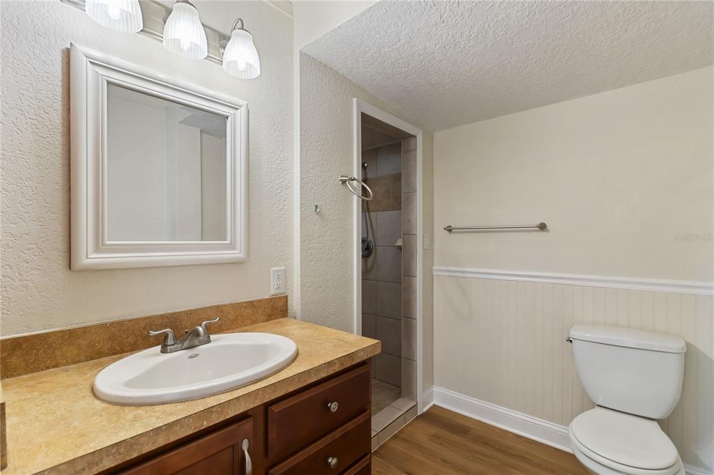 712 4th Street St. Cloud, FL 34769 - Photo 20 of 30 a bathroom with a sink a toilet and shower