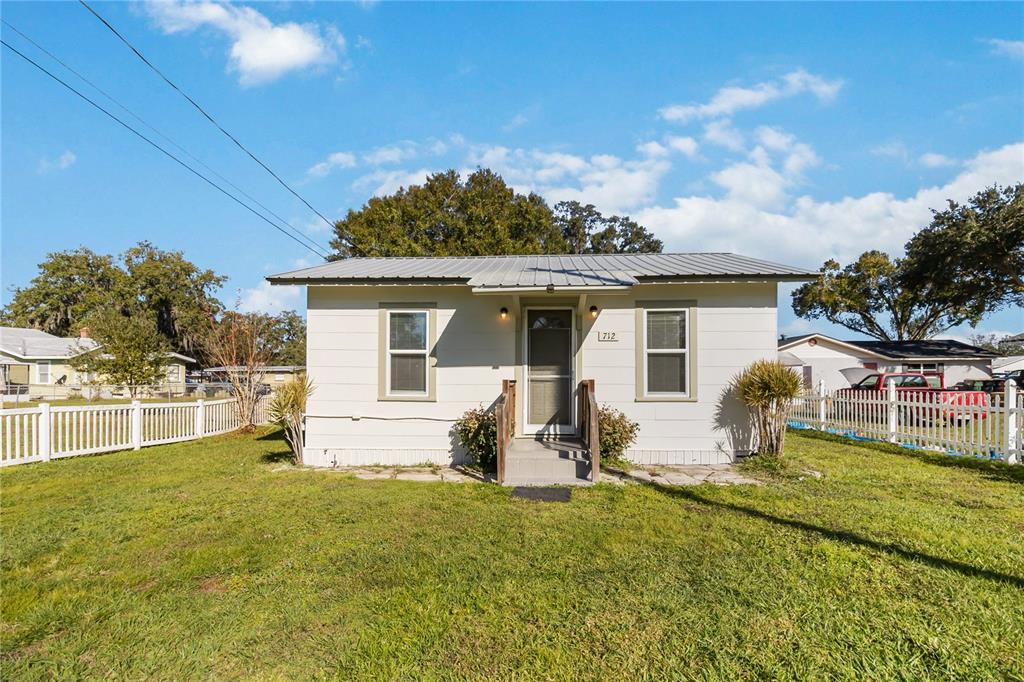 712 4th Street St. Cloud, FL 34769 - Photo 2 of 30 a front view of house with yard and outdoor seating