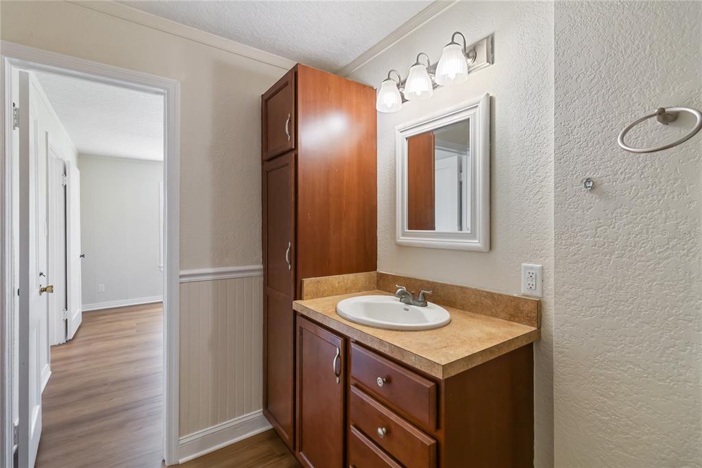712 4th Street St. Cloud, FL 34769 - Photo 21 of 30 a bathroom with a sink and a mirror