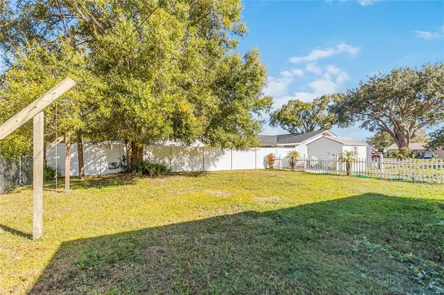 a view of a house with a big yard and swimming pool