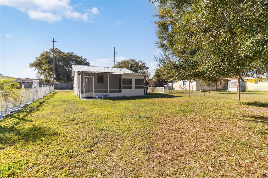712 4th Street St. Cloud, FL 34769 - Photo 30 of 30 a view of a house with a big yard and potted plants