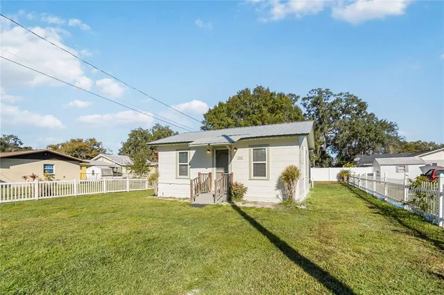 a house view with a sitting space and garden