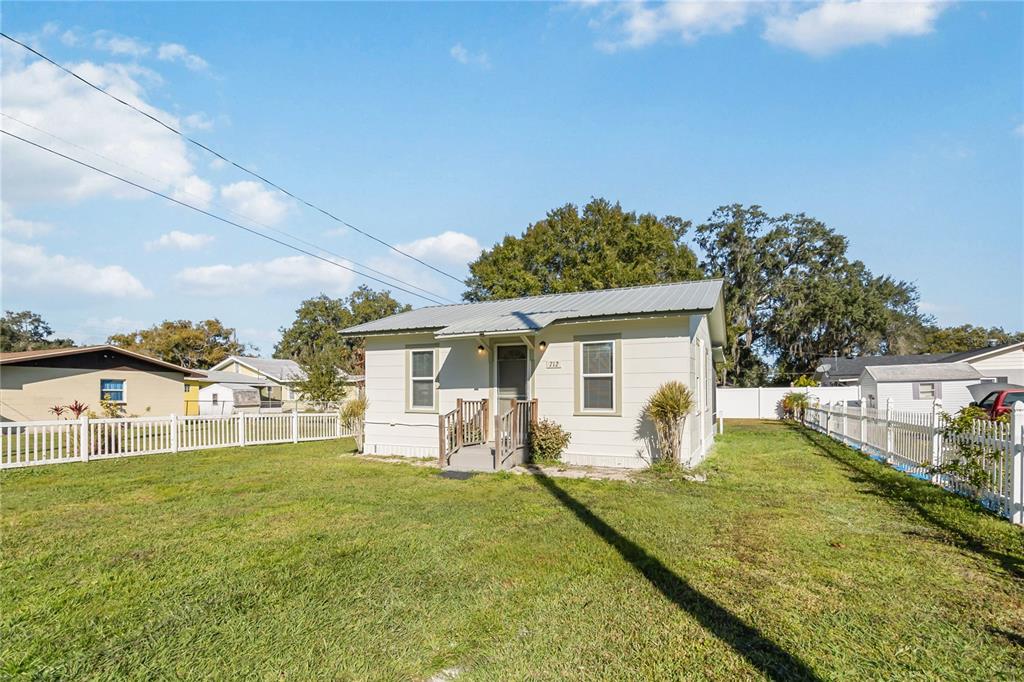 712 4th Street St. Cloud, FL 34769 - Photo 3 of 30 a house view with a sitting space and garden