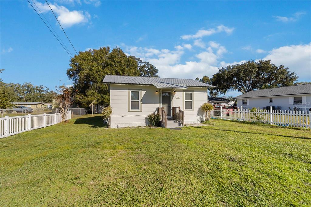712 4th Street St. Cloud, FL 34769 - Photo 4 of 30 a view of a house with backyard and sitting area