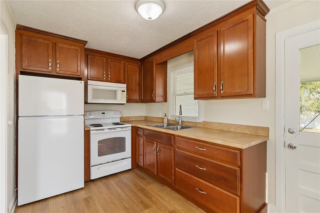 712 4th Street St. Cloud, FL 34769 - Photo 10 of 30 a kitchen with a sink a refrigerator and cabinets