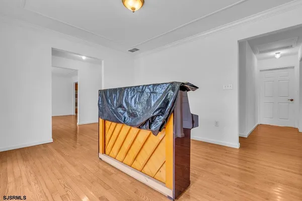 a view of an empty room with wooden floor