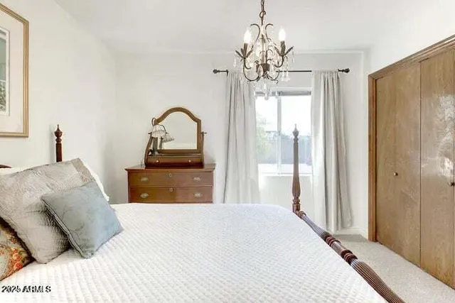 a bedroom with a bed and a chandelier