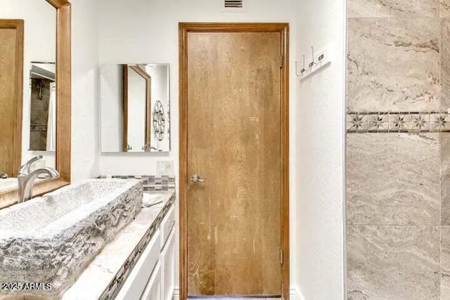 a bedroom with a bed and a dresser