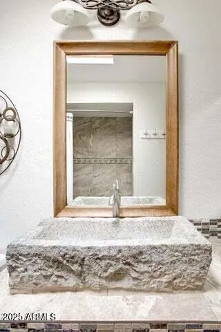 a bedroom with a bed and a chair