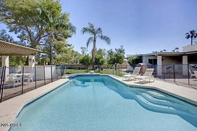 a view of a swimming pool with a patio