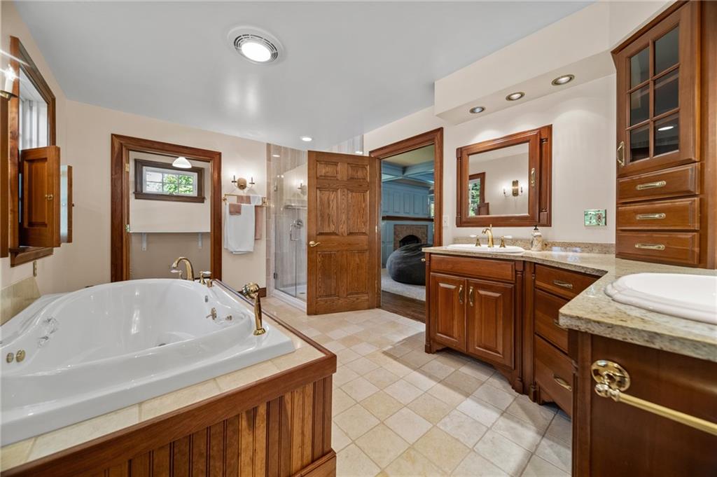 21368 Church Street Venango, PA 16440 - Photo 23 of 49 a spacious bathroom with a sink double vanity granite tub shower and a mirror