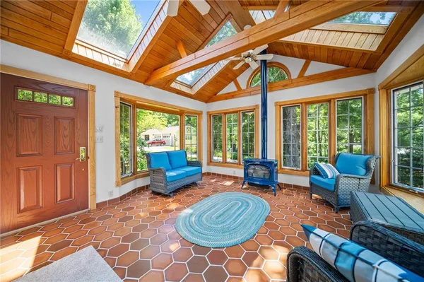 a living room with furniture and a floor to ceiling window