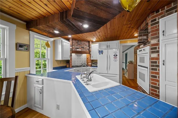 a kitchen with white cabinets and a stove