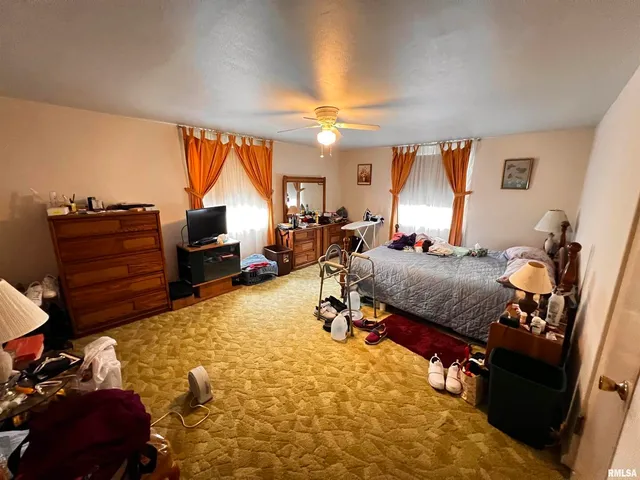 a bedroom with furniture and a window