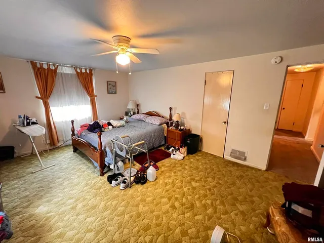 a bedroom with a bed and a mirror