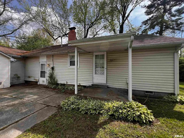 a view of house with backyard