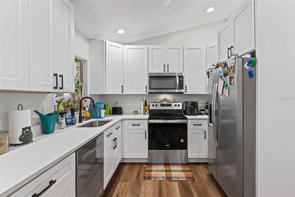 3721 43rd Avenue West Bradenton, FL 34205 - Photo 11 of 26 a kitchen with stainless steel appliances a sink stove and refrigerator