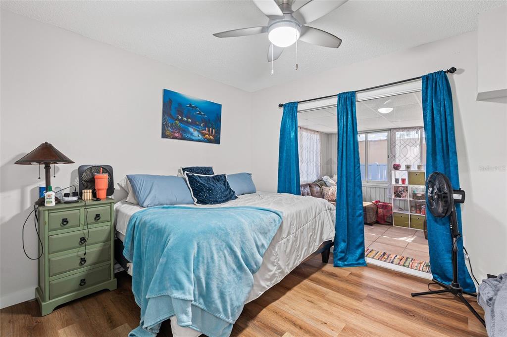 3721 43rd Avenue West Bradenton, FL 34205 - Photo 17 of 26 a bedroom with a bed and a chandelier