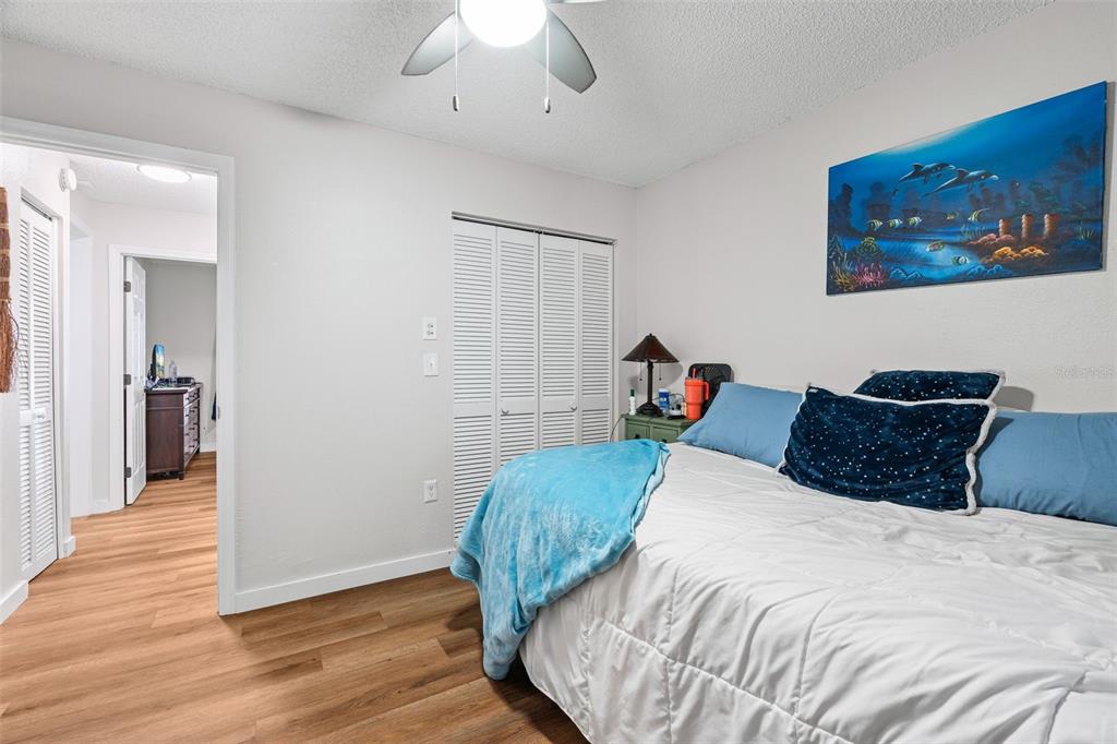 3721 43rd Avenue West Bradenton, FL 34205 - Photo 18 of 26 a bed room with a bed and a chandelier