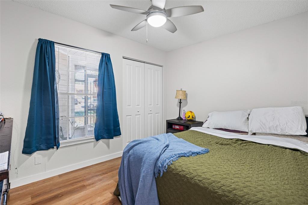 3721 43rd Avenue West Bradenton, FL 34205 - Photo 20 of 26 a bedroom with a bed and a chandelier