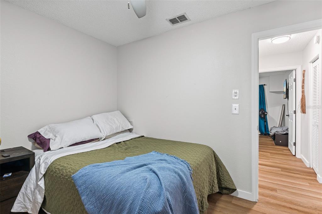 3721 43rd Avenue West Bradenton, FL 34205 - Photo 21 of 26 a bedroom with a bed and wooden floor