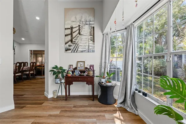 a living room with furniture floor to ceiling window and potted plant